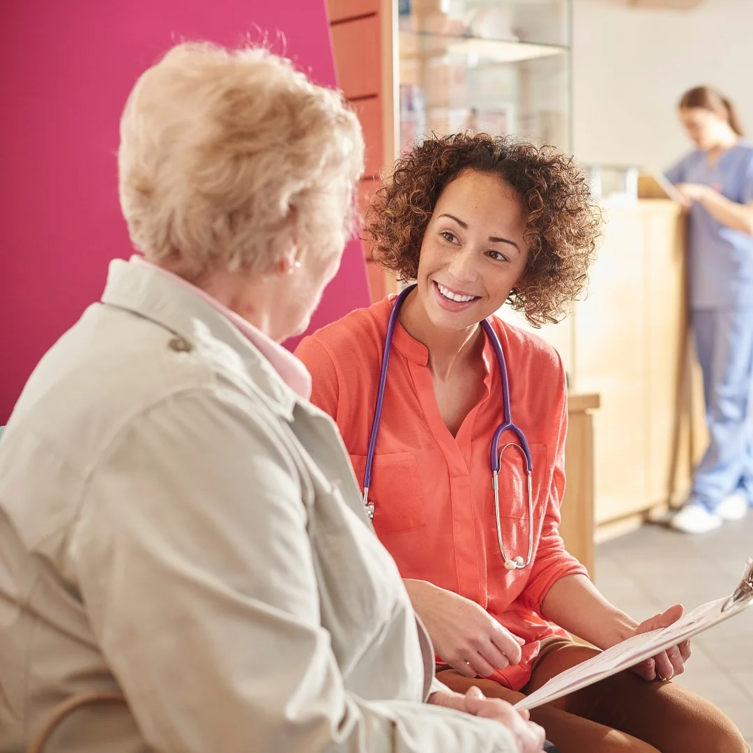 healthcare professional talking to older woman